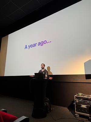 Youssef Boulkaid presenting his talk with the text ‘A year ago’ on the screen