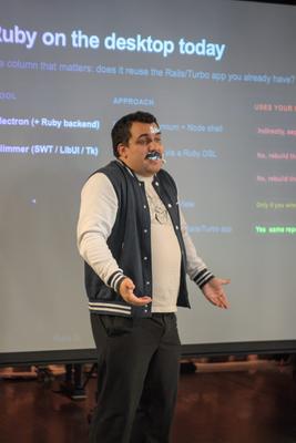 Augustin gesturing while presenting