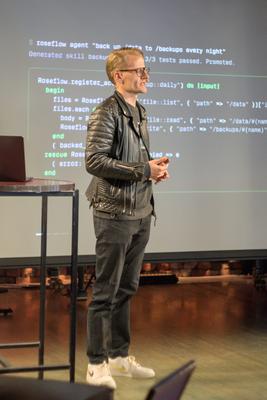 Lauri Jutila presenting 'Agentic Programmability' with code on screen